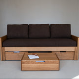Wooden sofa with storage drawers and a matching coffee table in a minimalistic setting.